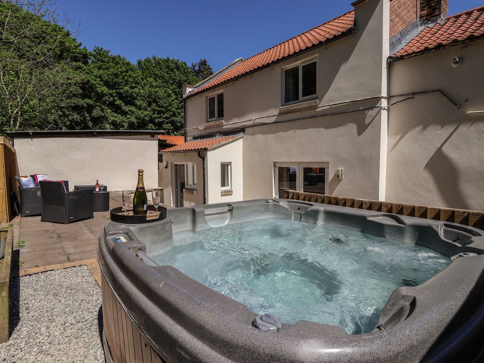 An outdoor area with a hot tub and seating at Sea View in Scarborough
