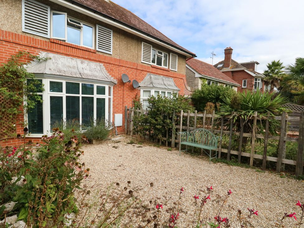 A garden with a bench and flowers at 29 Bincleaves Road Weymouth