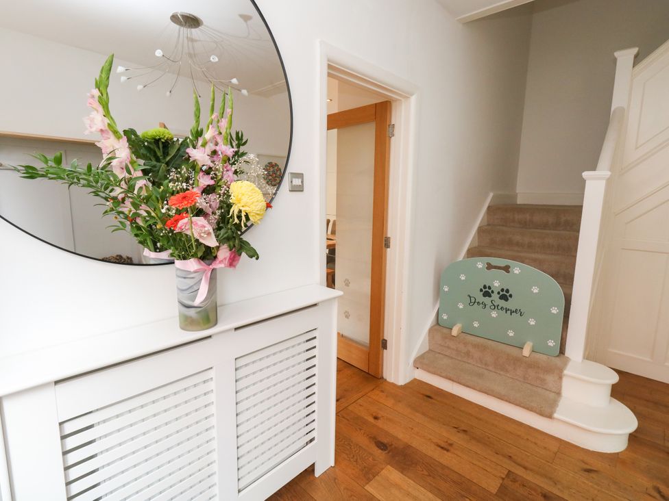 An entrance hall with a flower arrangement and a staircase at 29 Bincleaves Road Weymouth