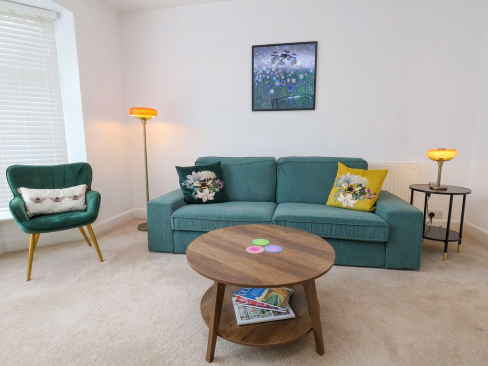A living room with a sofa and table at 29 Bincleaves Road, Weymouth