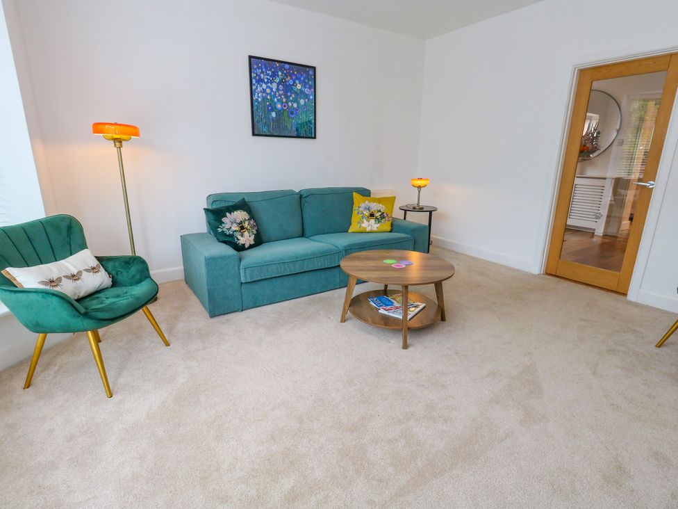 A living room with a sofa and armchair at 29 Bincleaves Road in Weymouth