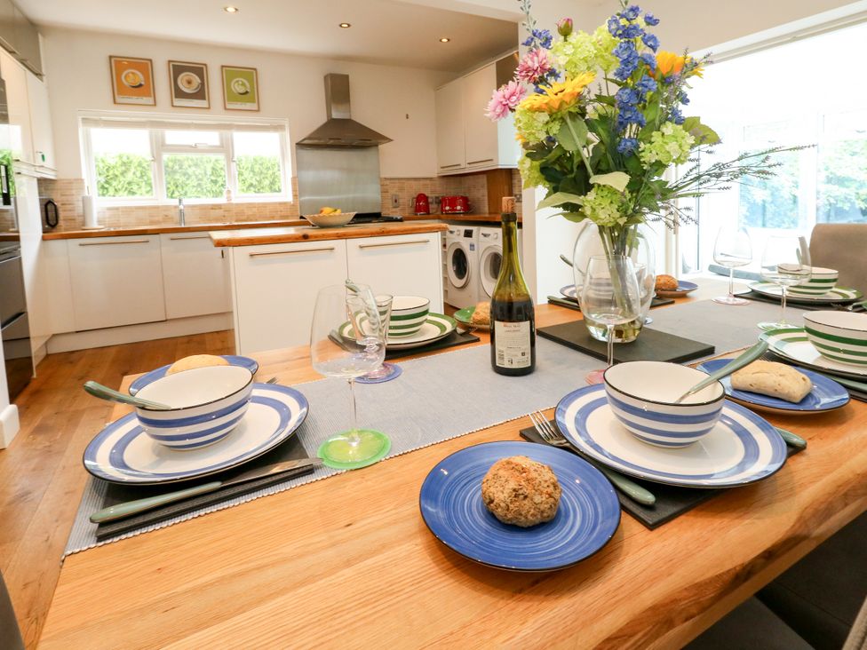 A kitchen with a dining table set for a meal at 29 Bincleaves Road Weymouth