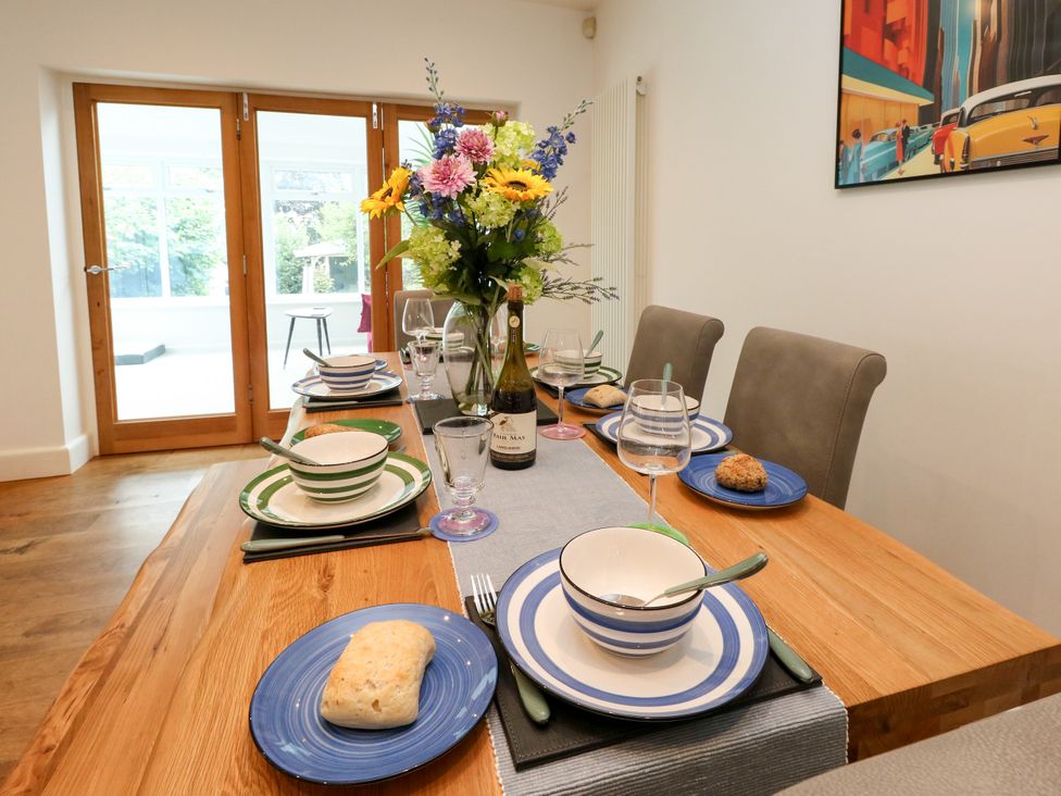A dining room with a table set for a meal at 29 Bincleaves Road Weymouth