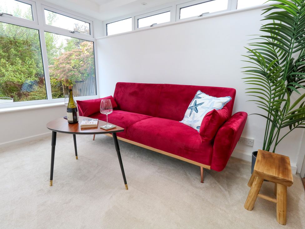 A living room with a sofa and a table at 29 Bincleaves Road in Weymouth