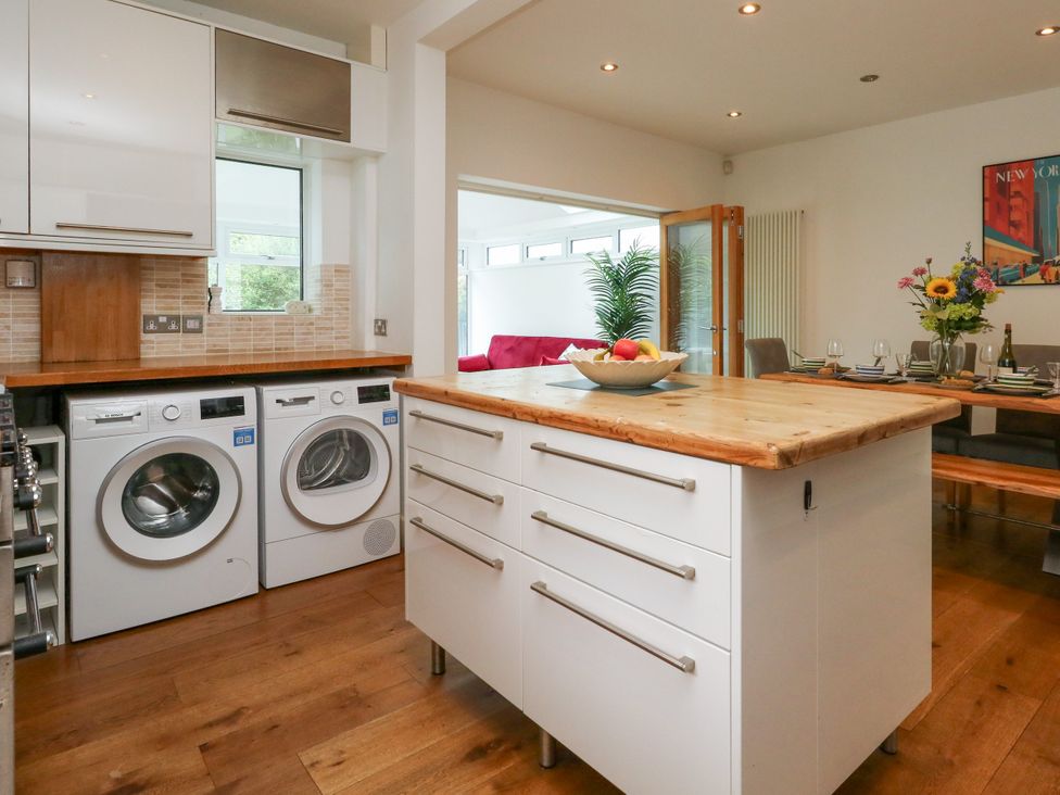 A kitchen with washing machine and dryer at 29 Bincleaves Road Weymouth