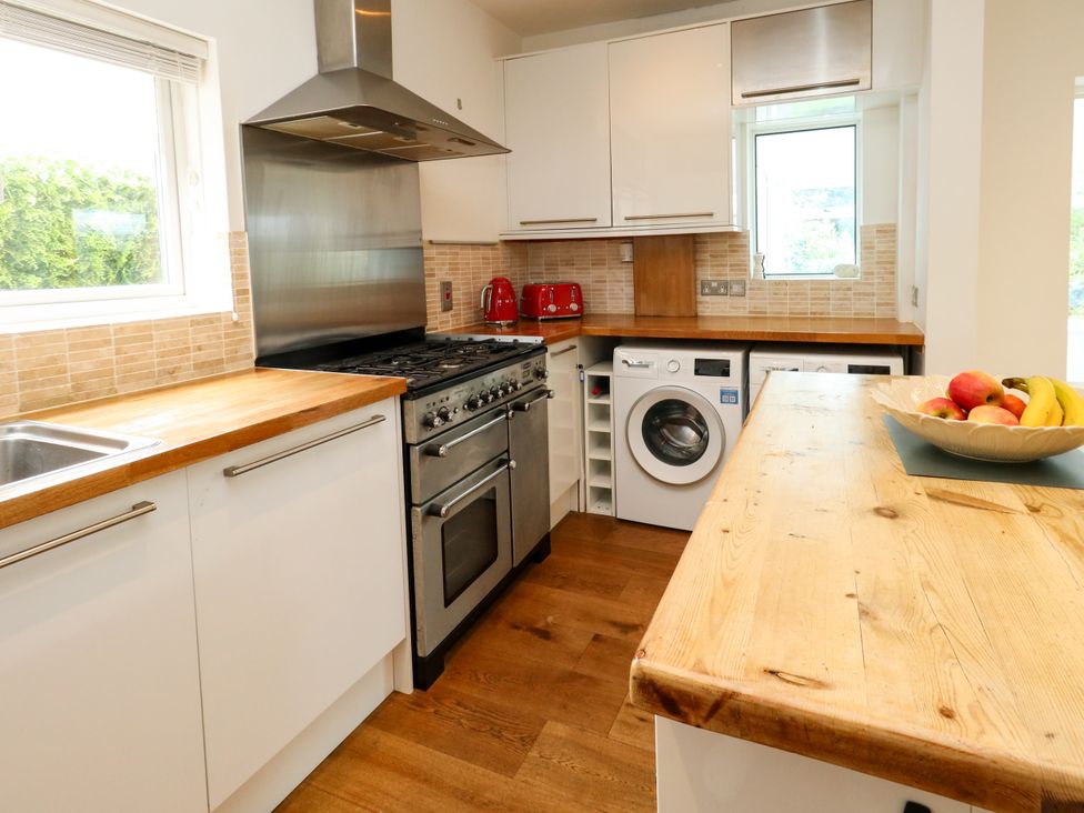 A kitchen with stainless steel appliances and wooden countertop at 29 Bincleaves Road in Weymouth