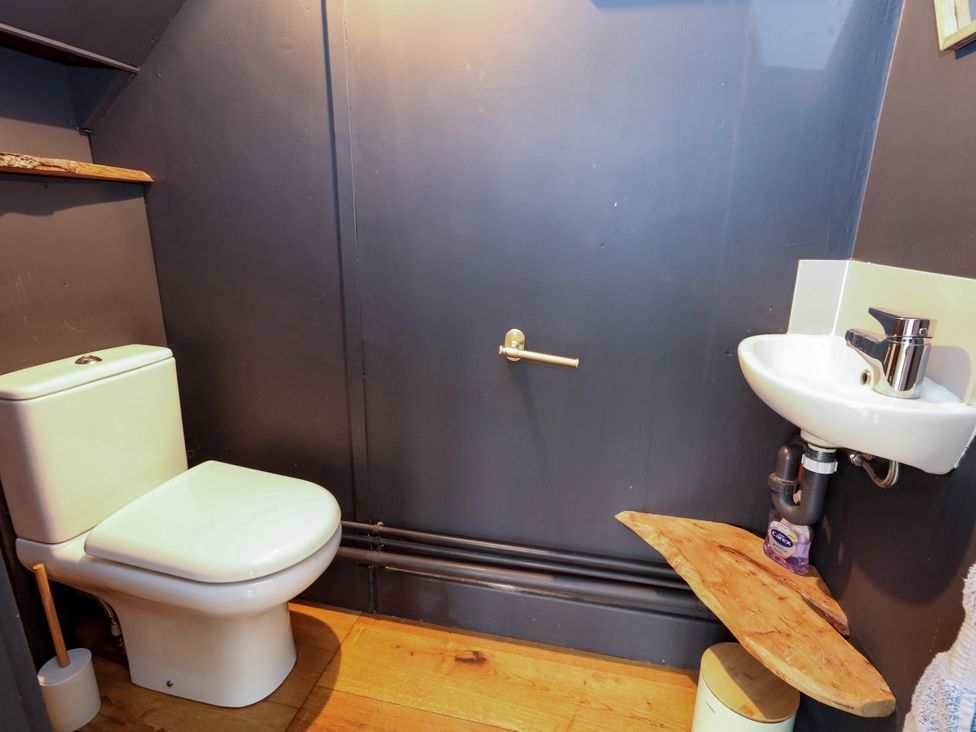 A bathroom with a toilet and sink at 29 Bincleaves Road in Weymouth