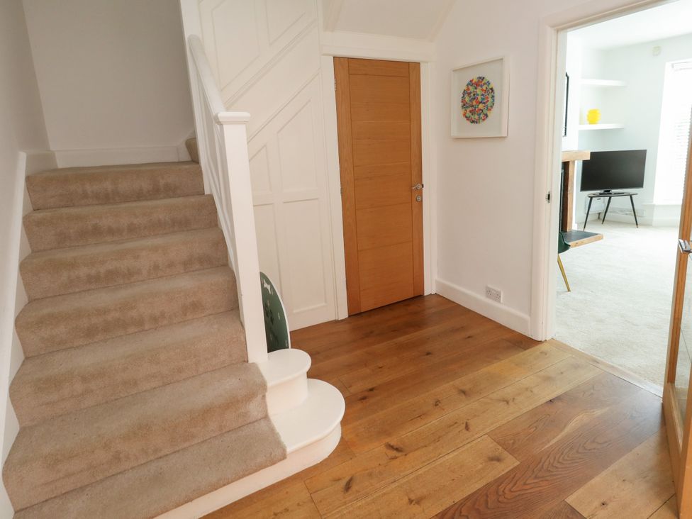 A hallway with stairs and a door at 29 Bincleaves Road Weymouth