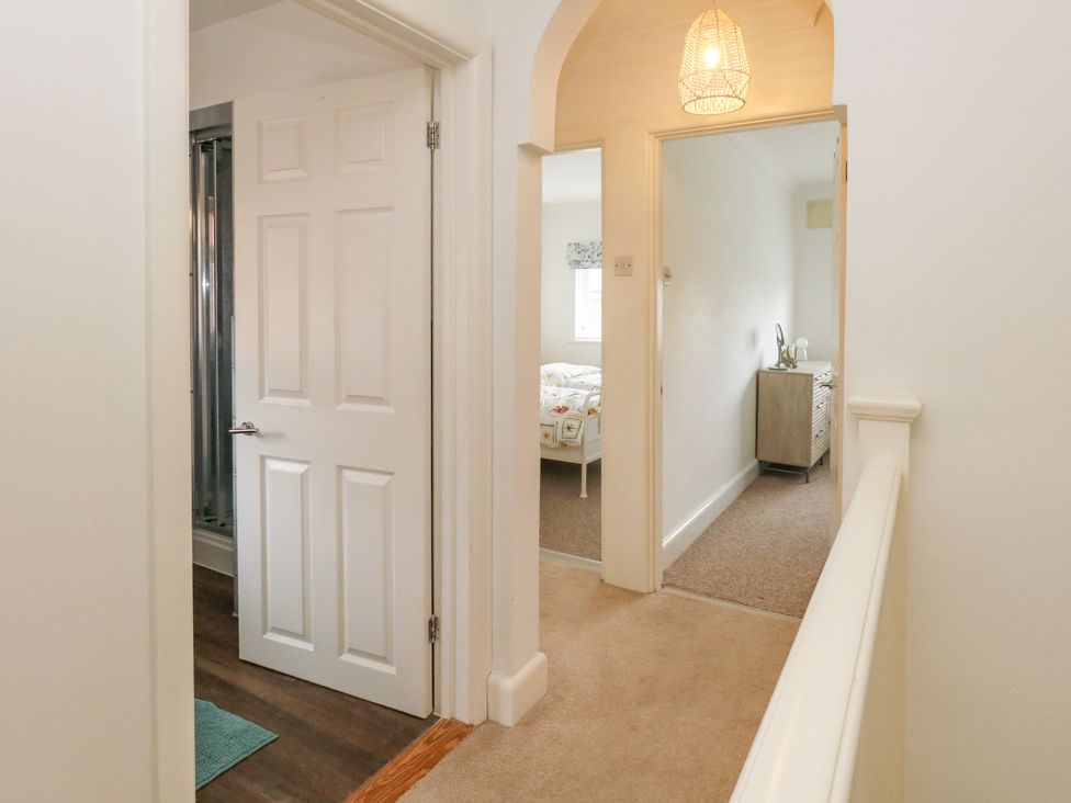 A hallway with doors and a shower in view at 29 Bincleaves Road Weymouth