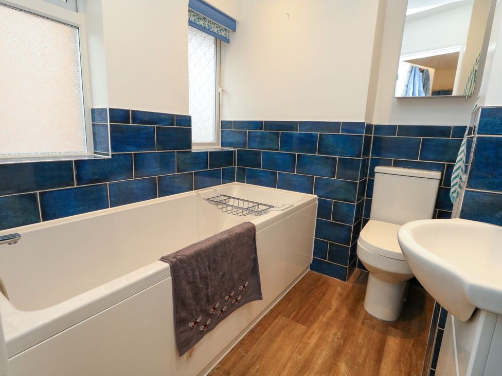 A bathroom with a bathtub, toilet, and sink at 29 Bincleaves Road Weymouth