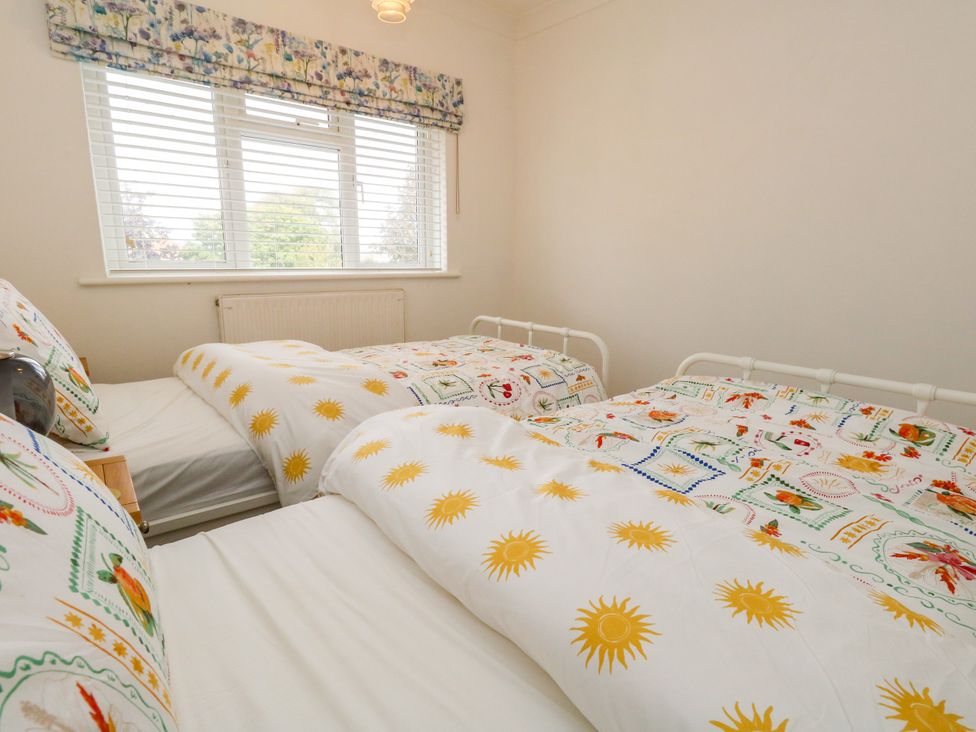 A bedroom with two beds and a window at 29 Bincleaves Road Weymouth