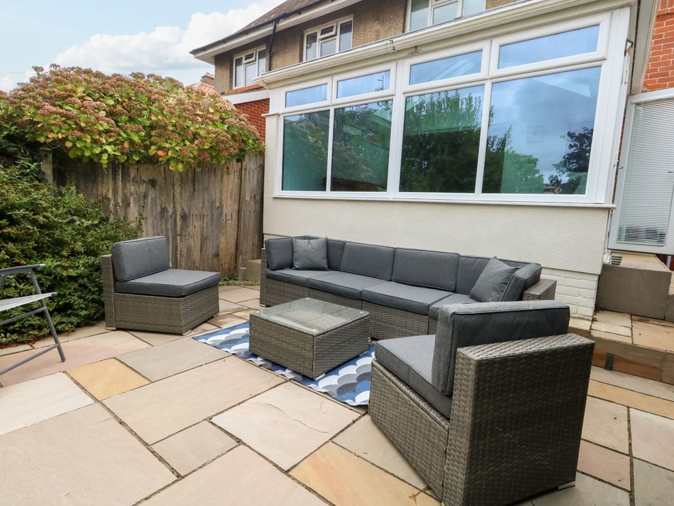 A garden with seating area and coffee table at 29 Bincleaves Road Weymouth