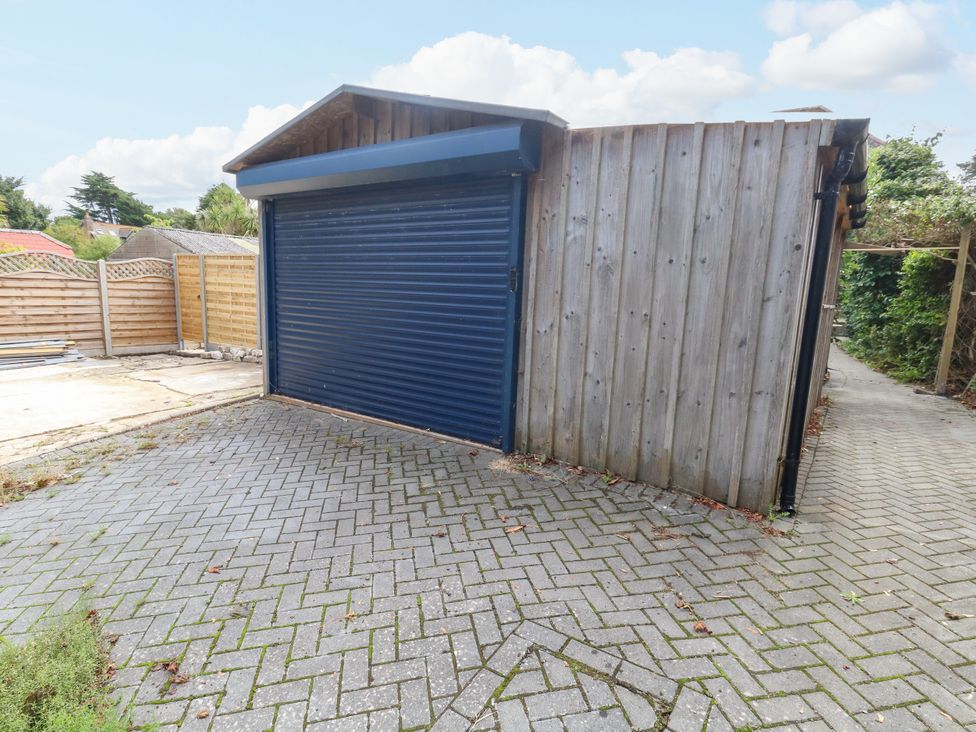 A garage with a blue door on an outdoor driveway at 29 Bincleaves Road Weymouth