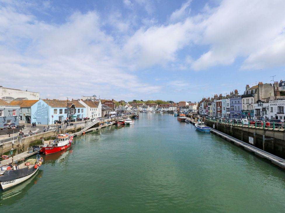 A waterfront view with boats and buildings at 29 Bincleaves Road Weymouth