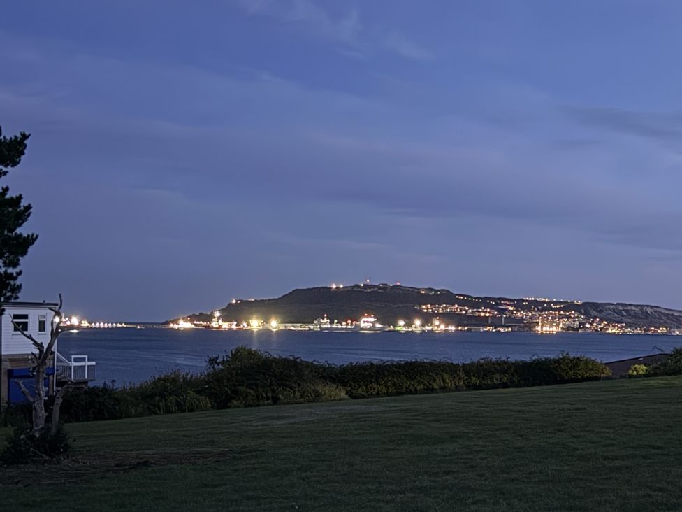 A view of an island with lights at Coast Path Cottage in Weymouth