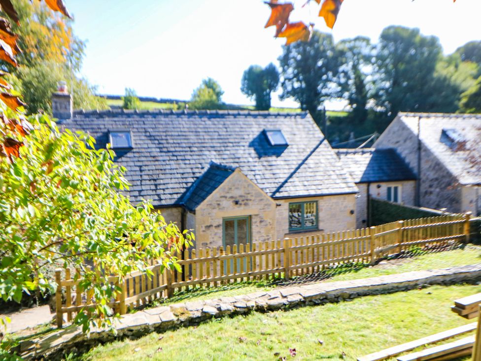 An exterior view of a house with a fence at Stone Lily Cottage