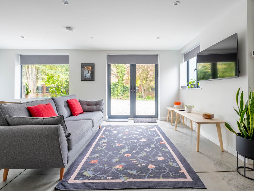 A living room with a sofa and a television at Blackwood in Hornsea