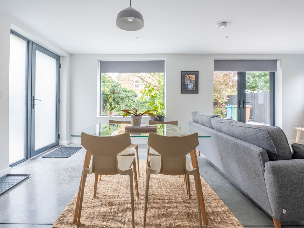 A living room with a glass table and grey sofa at Blackwood in Hornsea