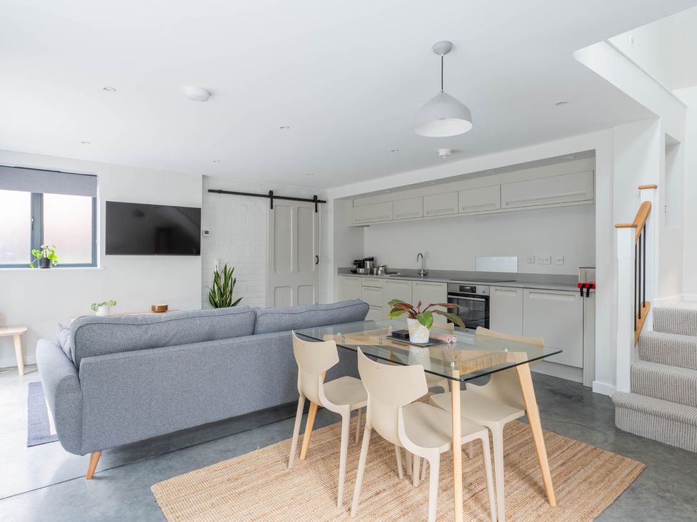 A living room with a sofa and dining table at Blackwood in Hornsea