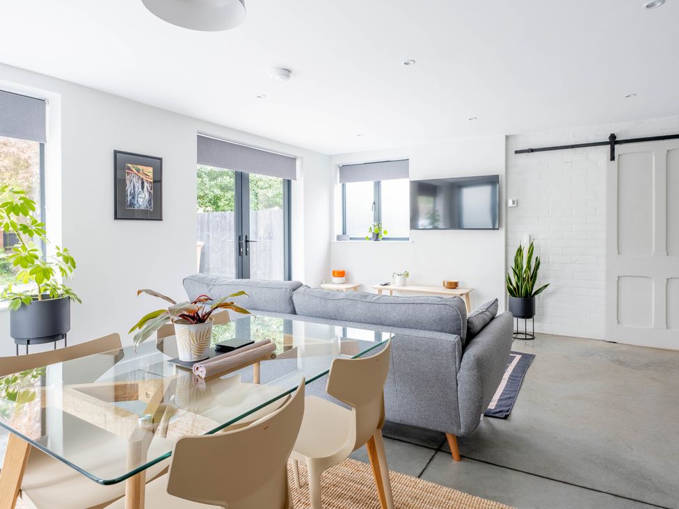 A living room with a sofa and dining table at Blackwood in Hornsea