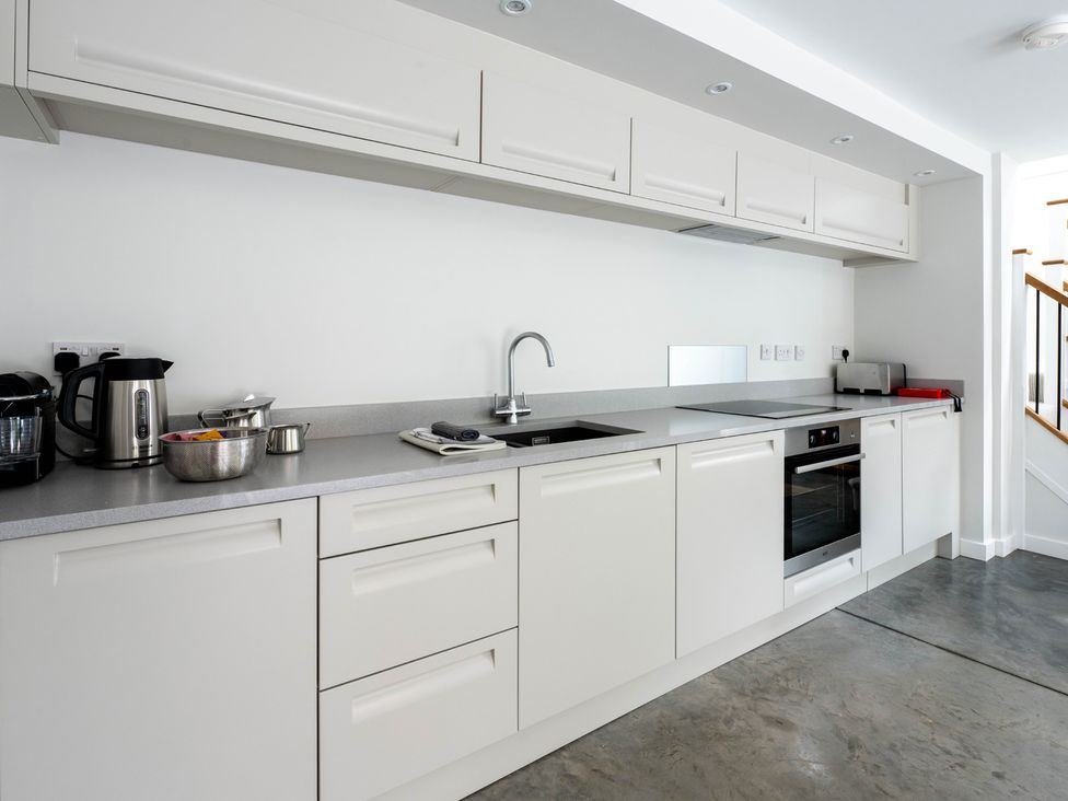 A kitchen with a sink and stove at Blackwood in Hornsea