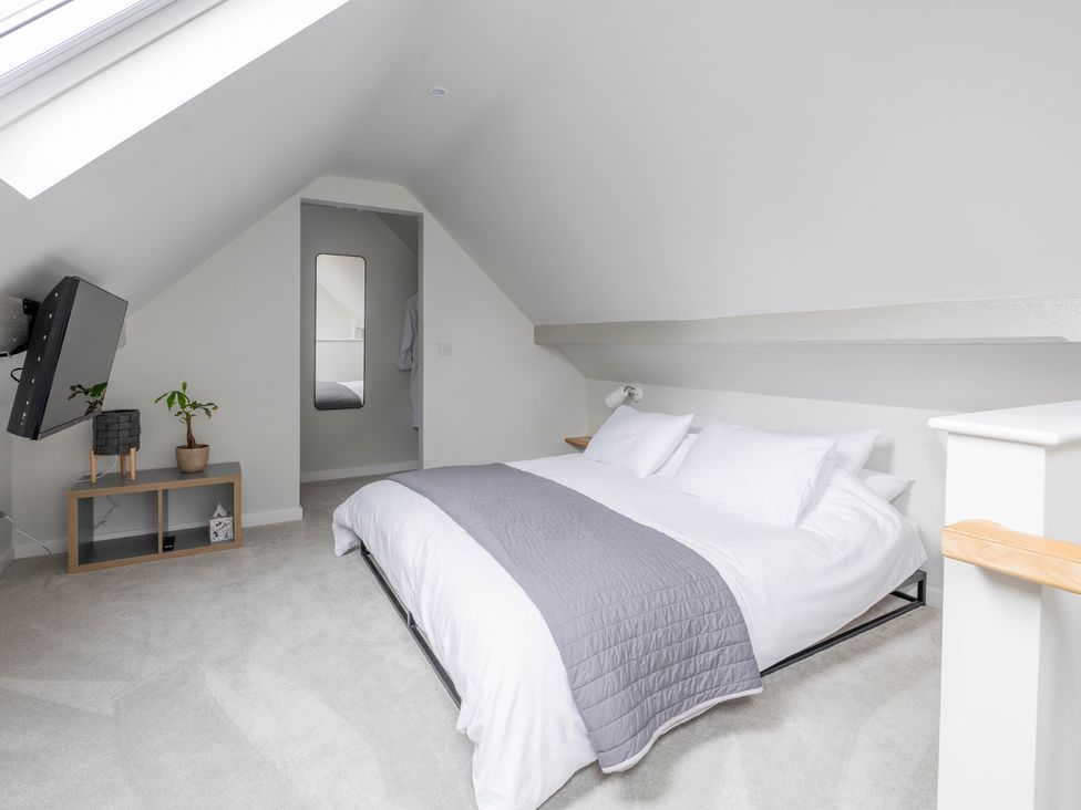 A bedroom with a bed and television at Blackwood in Hornsea