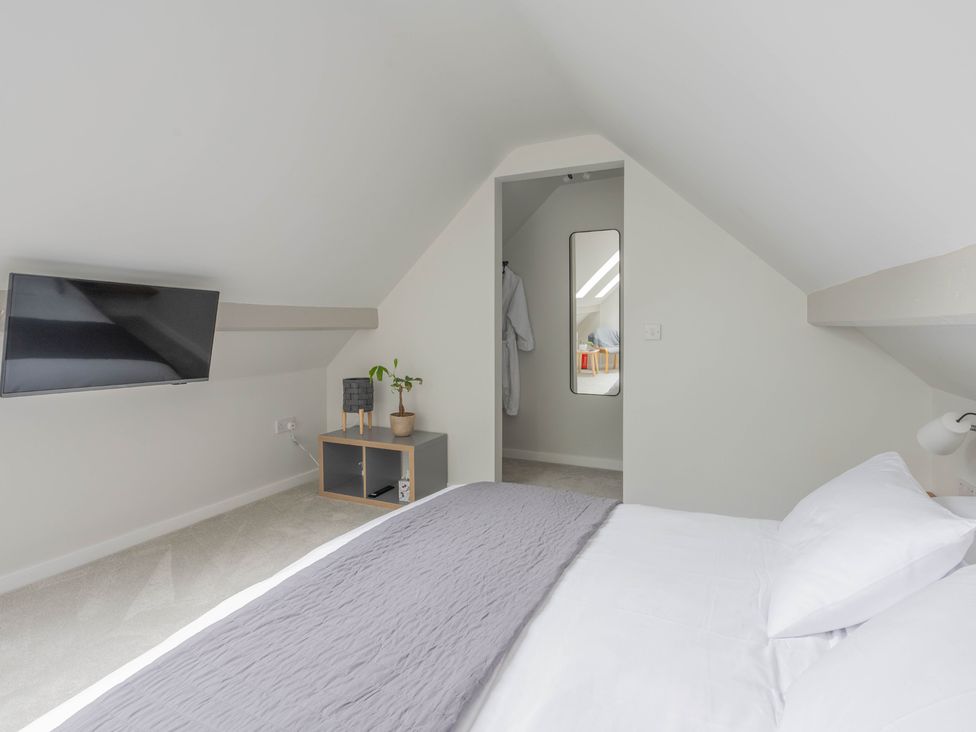 A bedroom with a bed and television at Blackwood in Hornsea