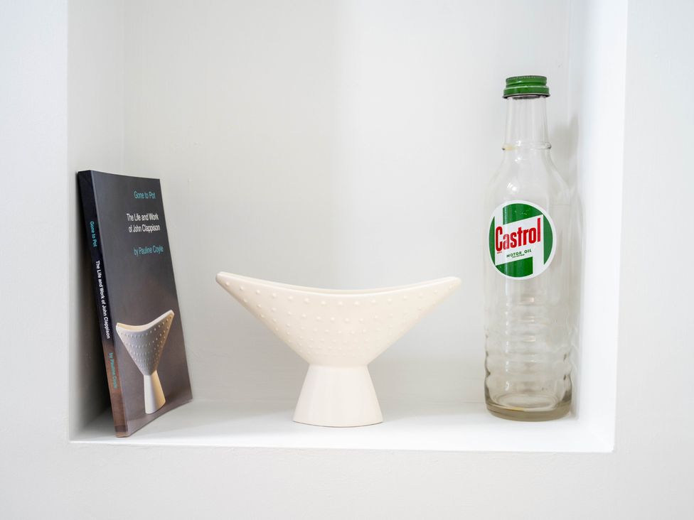 A nook with a book, a vase and a bottle at Blackwood in Hornsea