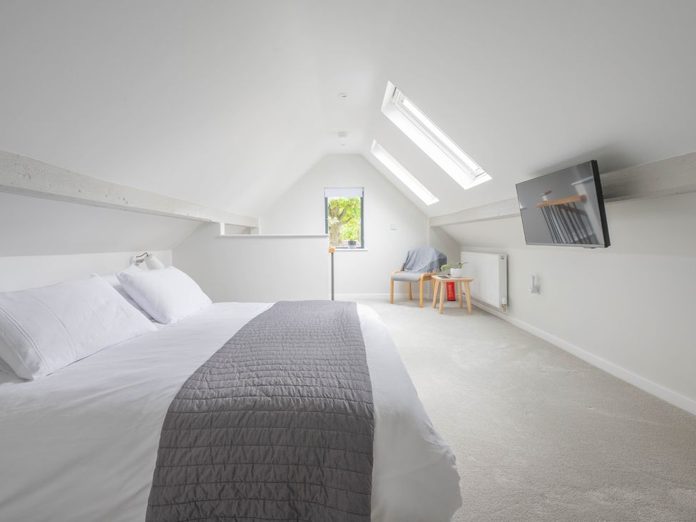 A bedroom with a bed and television at Blackwood in Hornsea