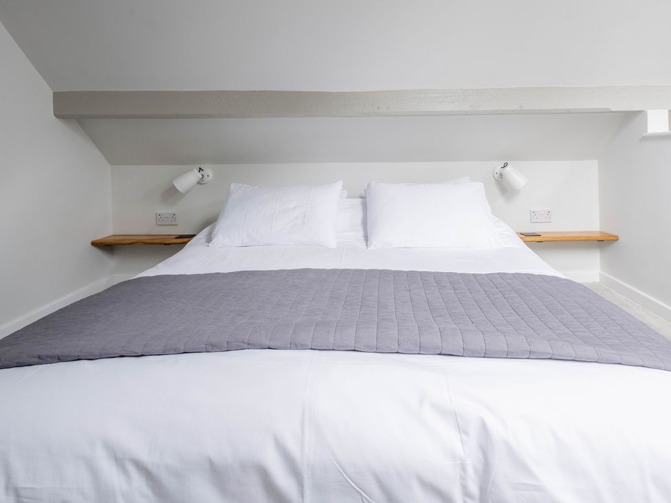 A bedroom with a bed and bedside light at Blackwood Hornsea
