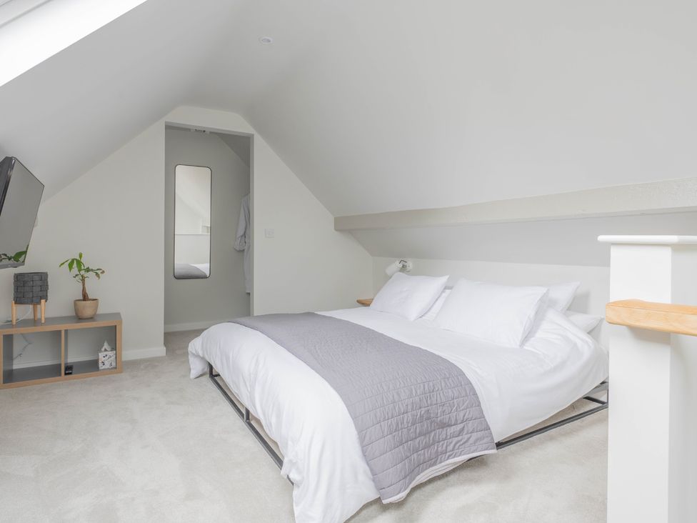 A bedroom with a bed and television at Blackwood in Hornsea