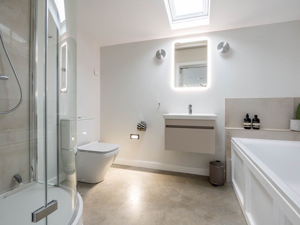A bathroom with a shower, toilet, sink, and bath at Blackwood in Hornsea