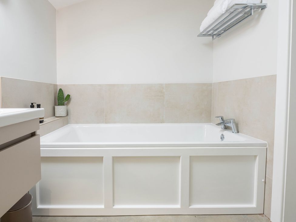 A bathroom with a bathtub and sink at Blackwood in Hornsea