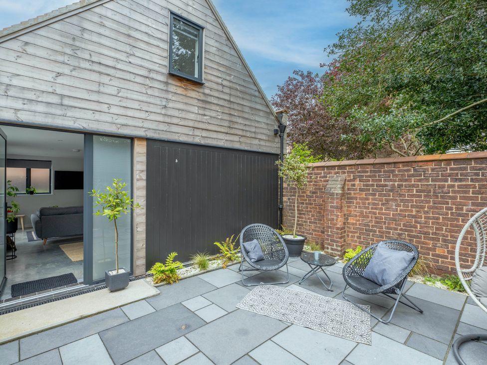 A patio area with chairs and a table at Blackwood in Hornsea