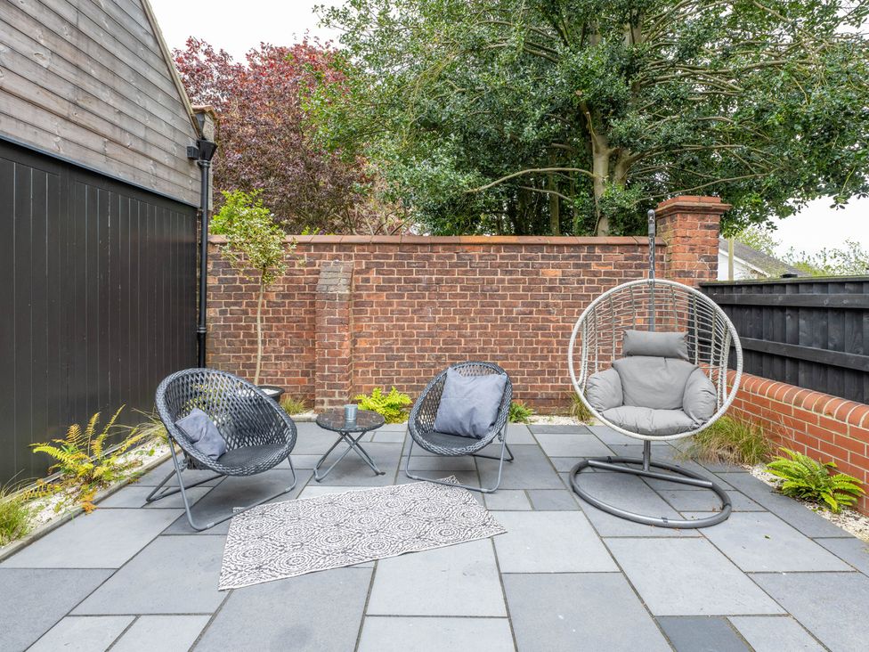 A garden with chairs and a hanging chair at Blackwood in Hornsea