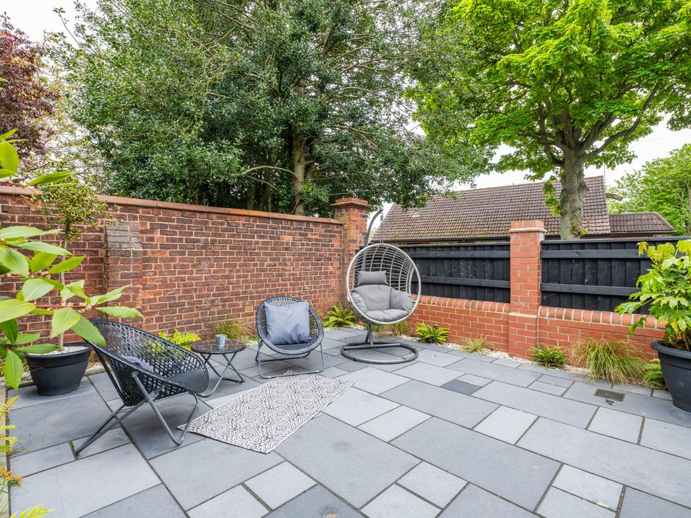 A garden with outdoor furniture and a hanging chair at Blackwood in Hornsea