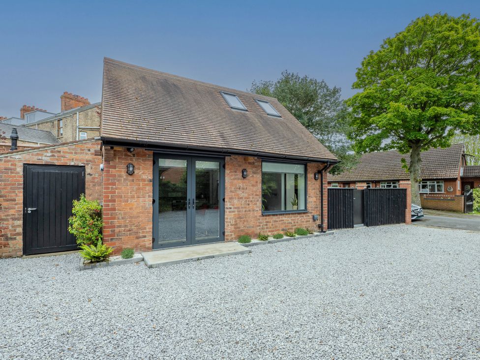 A house with a gravel driveway and greenery at Blackwood in Hornsea