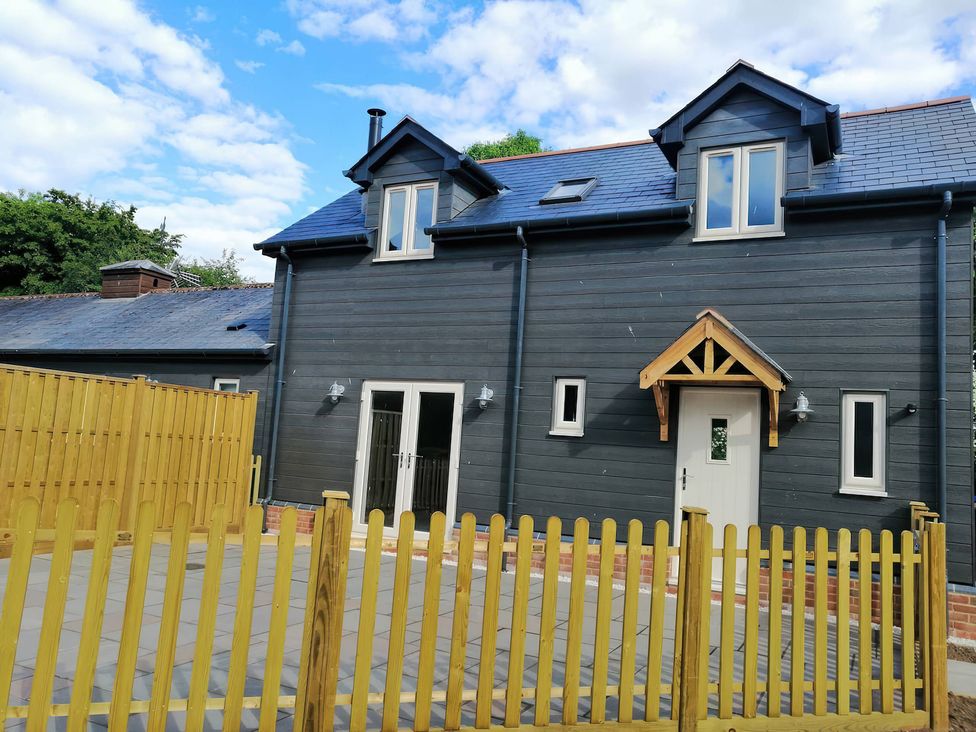 A house with a yellow fence and windows at TBC 