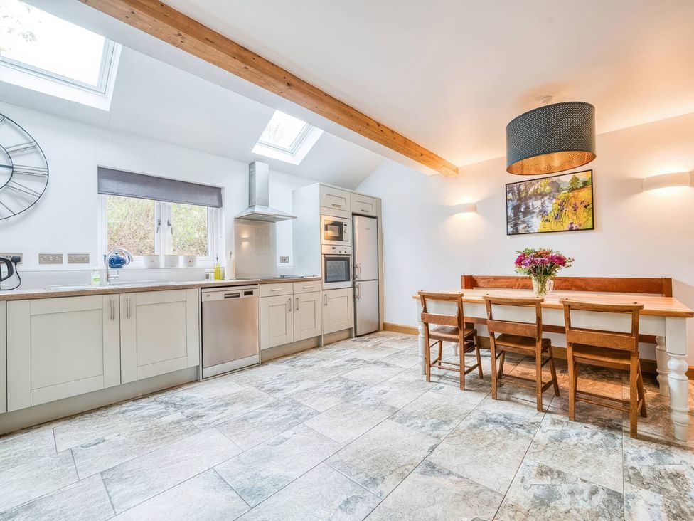 A kitchen with a table and chairs at TBC
