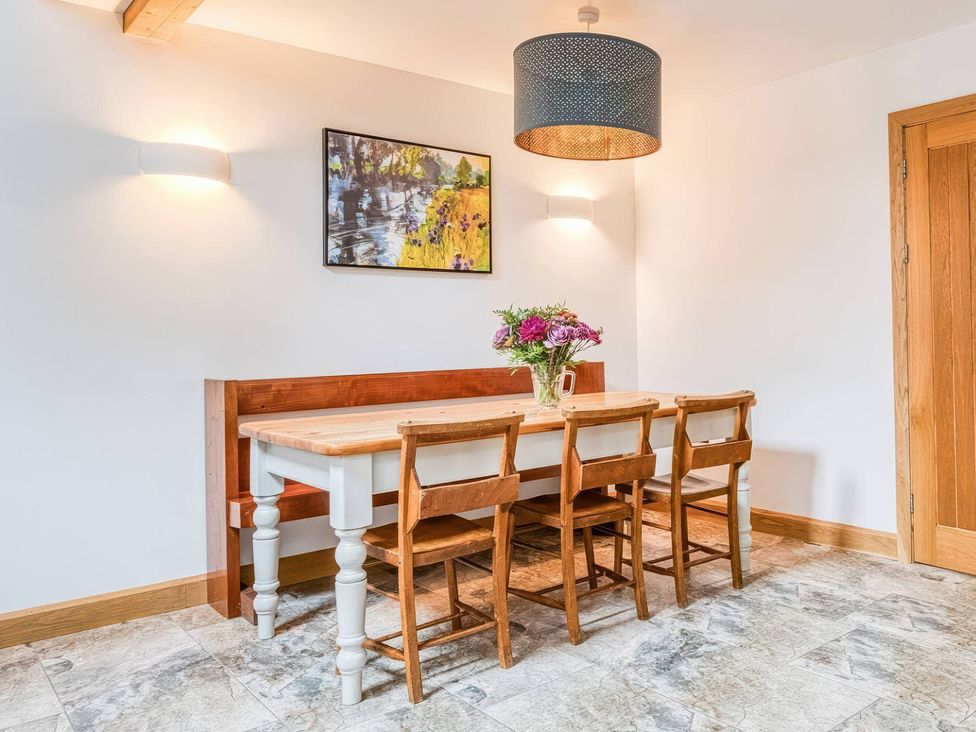 A dining room with a table and chairs at TBC 