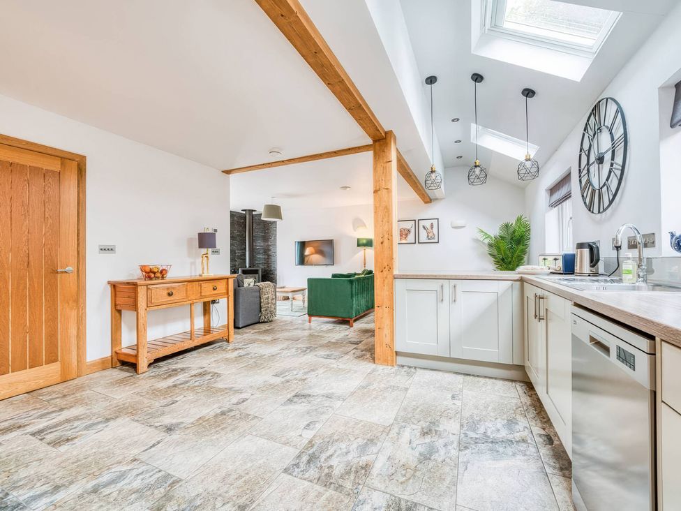 A kitchen with a console table and sofa at TBC in 