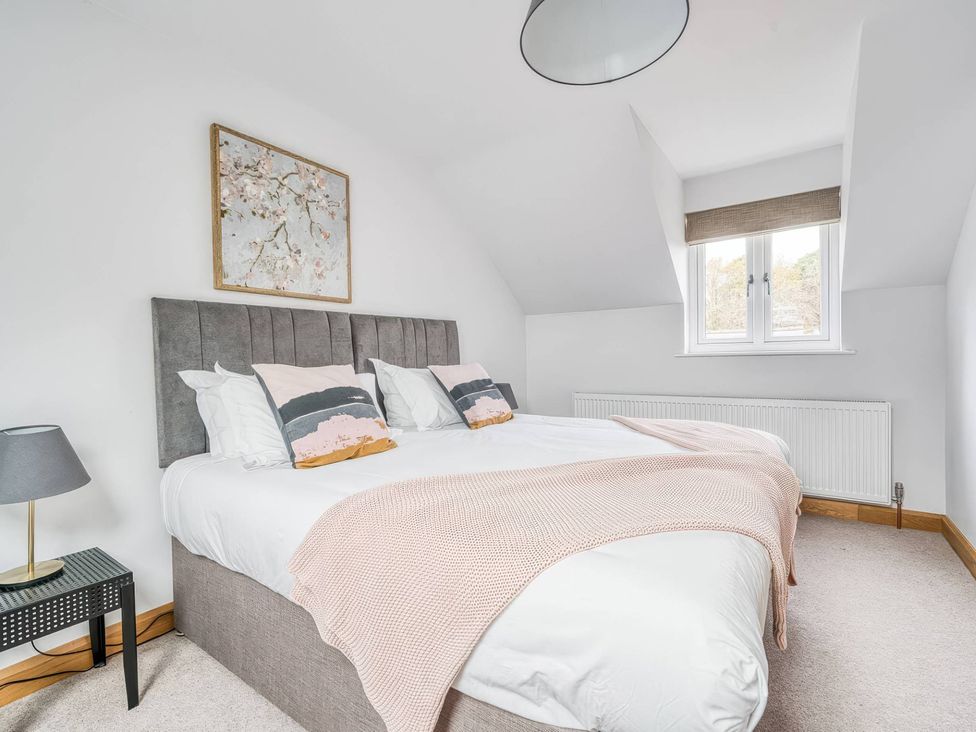 A bedroom with a double bed and a painting at TBC