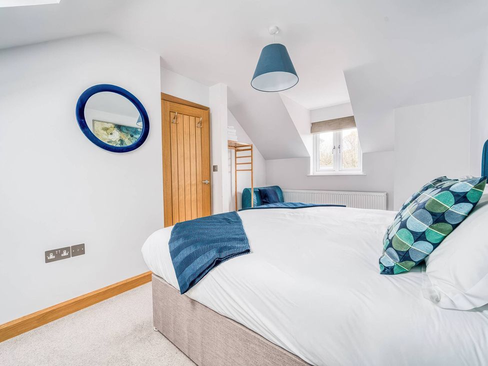 A bedroom with a bed and mirror at TBC in 