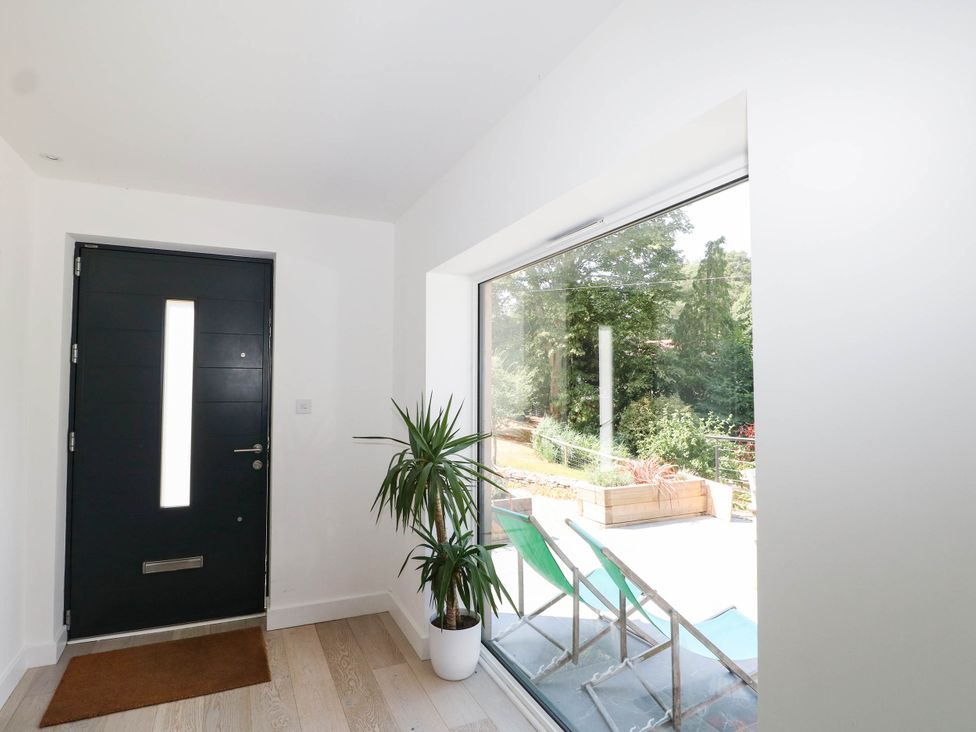 An entrance hall with a door and a large window at Cree Cottage