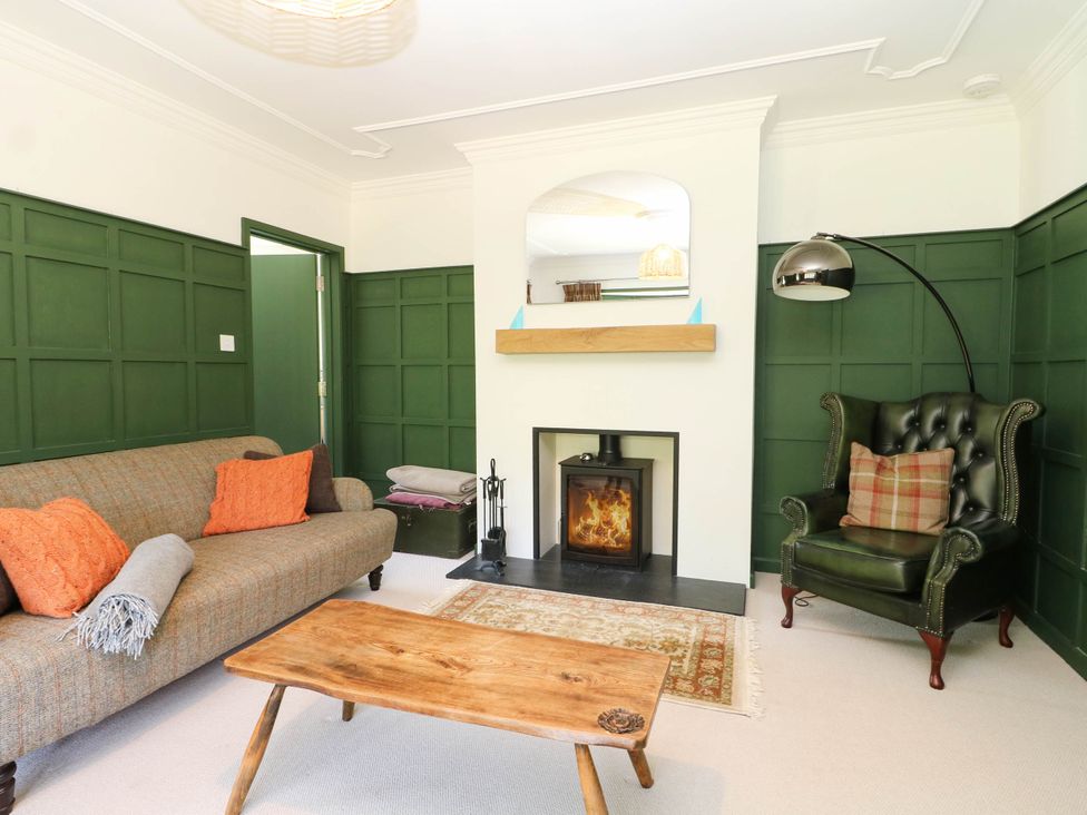 A living room with a sofa and fireplace at Cree Cottage