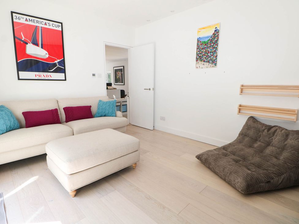 A living room with a couch and ottoman at Cree Cottage