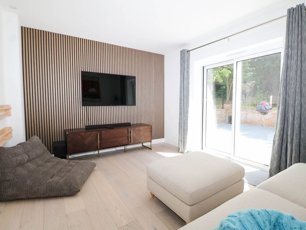 A living room with a television and a couch at Cree Cottage