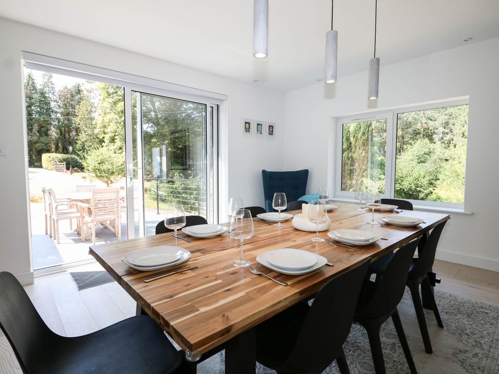 A dining room with a wooden table and chairs at Cree Cottage