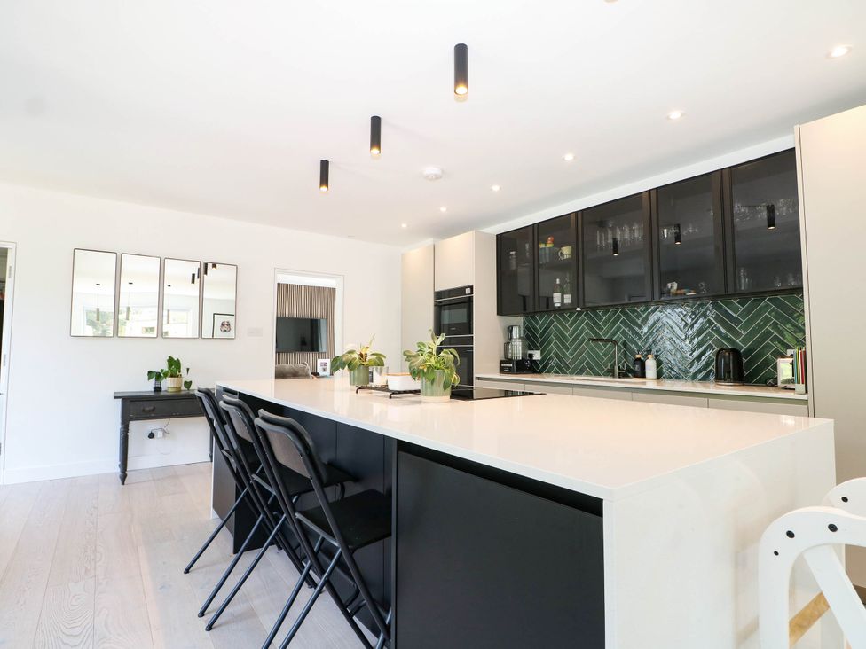 A kitchen with island and stools at Cree Cottage