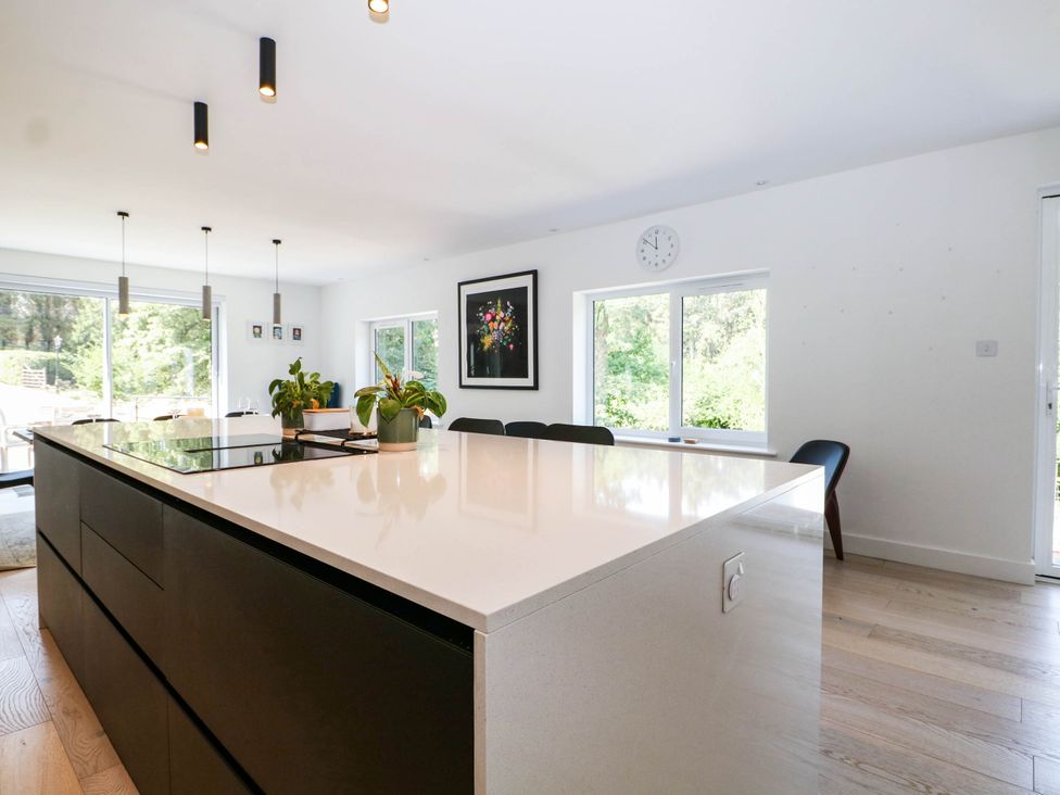 A kitchen with an island and windows at Cree Cottage